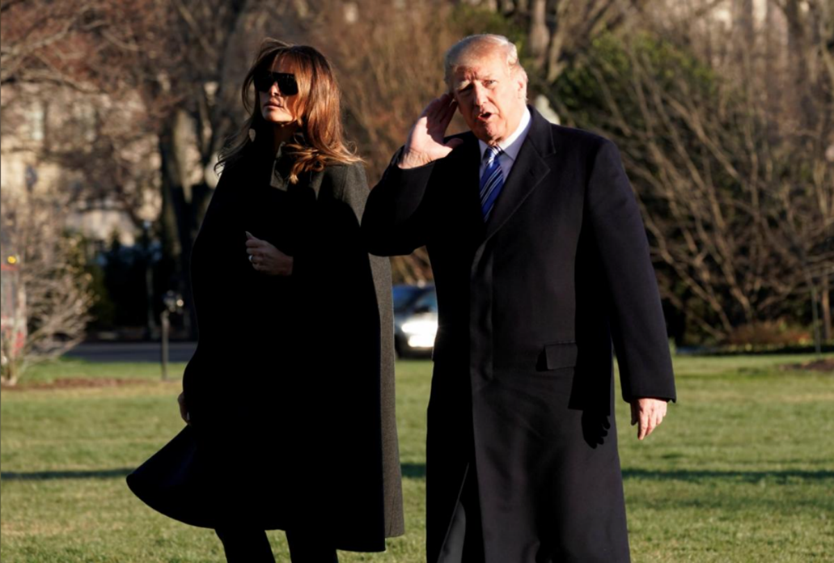 U.S. President Donald Trump listens to reporters as walks with first lady Melania Trump on South Lawn of the White House upon their return to Washington, U.S., from Palm Beach, Florida