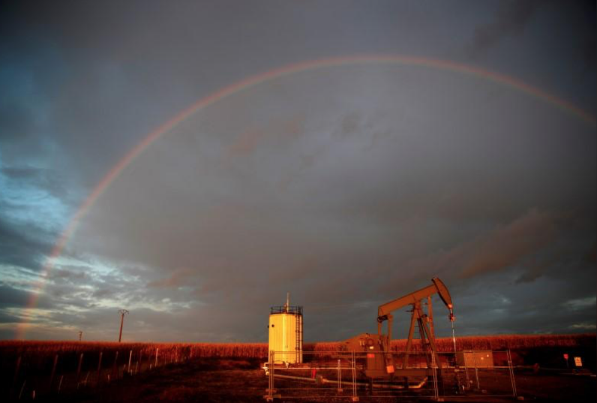 A rainbow is seen over a pumpjack during sunset outside Scheibenhard, near Strasbourg, France, October 6, 2017. REUTERS/Christian Hartmann