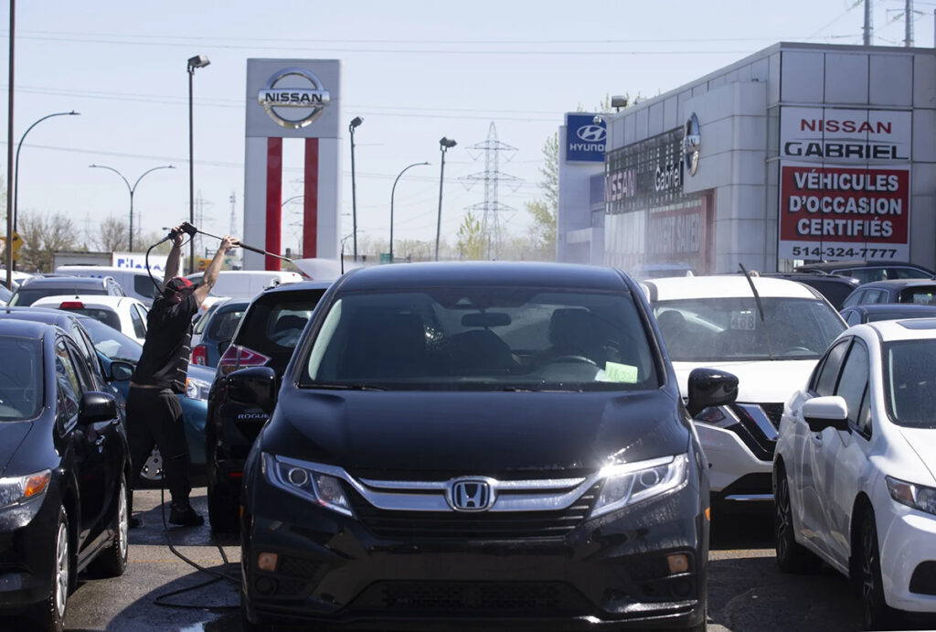 trump’s tariff whiplash is designed to sow chaos, trudeau says 1 a worker at a car dealership in montreal