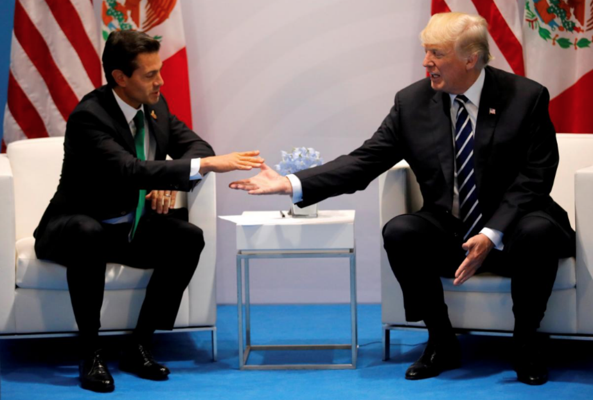 FILE PHOTO - U.S. President Donald Trump shakes hands with Mexico's President Enrique Pena Nieto during the their bilateral meeting at the G20 summit in Hamburg, Germany July 7, 2017. REUTERS/Carlos Barria/File Photo