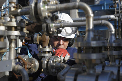 Worker looking at valves