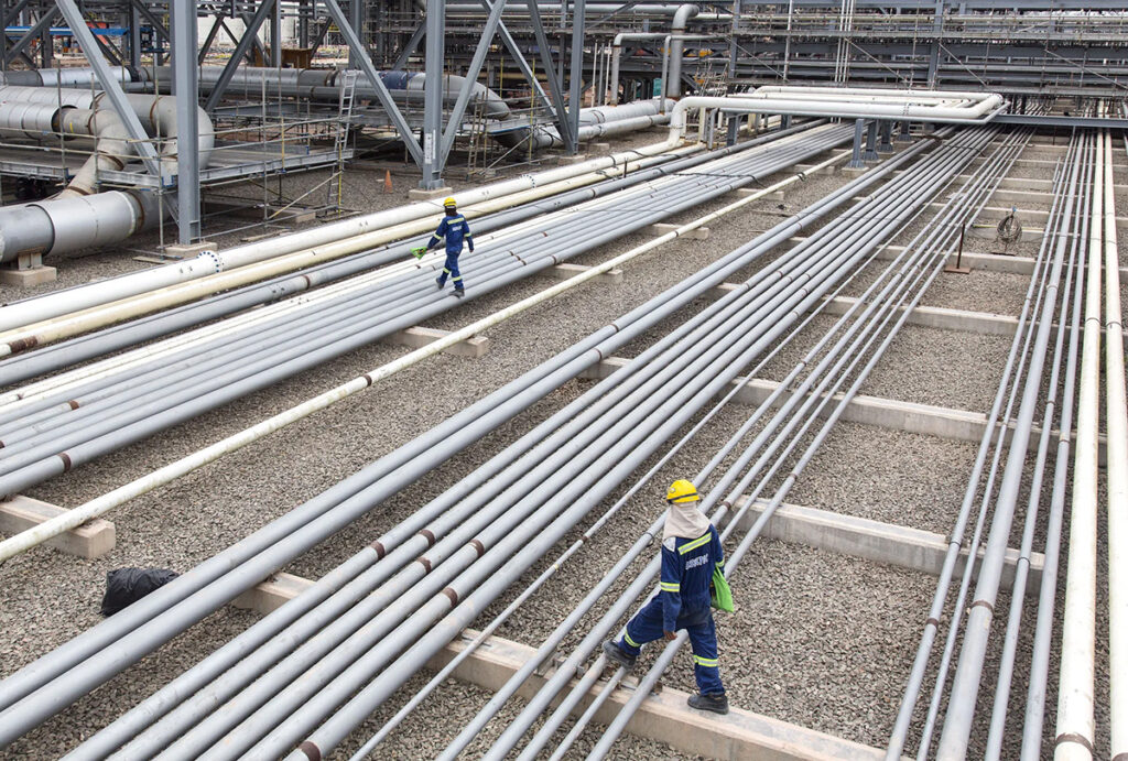 workers at a petroliam nasional bhd. site in johor, malaysia 1200x810
